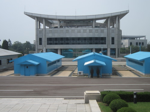 Visiting the DMZ from the north side in 2013. The demarcation line runs through the middle of these huts. The large building in the background is in South Korea.